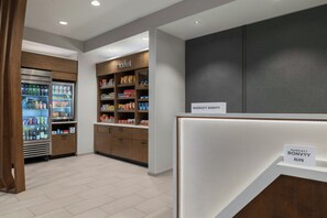 A hotel lobby with a self-service beverage station, a snack bar, and a reception desk. - Springhill Suites By Marriott Abilene (Abilene)
