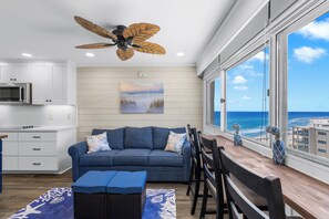 A modern kitchen with white cabinets, a microwave, and a ceiling fan. - Pinnacle Port A725 | Indoor & Outdoor Pools | On-Site Dining | My Beach Getaways (Panama City Beach)