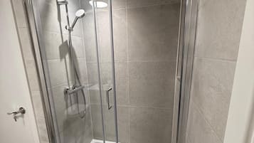 Shower, hair dryer, towels, toilet paper