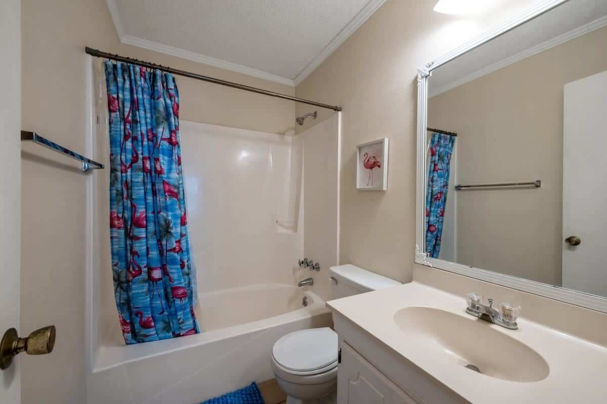 A bathroom with a bathtub, toilet, and sink.