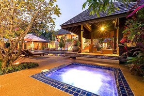 A spa area with a hot tub, lounge chairs, and a covered seating area. - Villa Samakee (Choeng Thale)