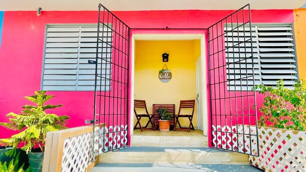 A staircase leading to a room with a 'hello' sign, a chair, and a table.