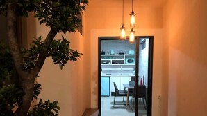 A narrow hallway with a dining area visible through an open door. - La casa de mi tia divorciada Family (Zapopan)