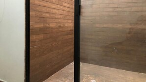 A narrow hallway with wooden walls and a black door frame. - Joint apartments near Bello Ant’s Town Square (Bello)