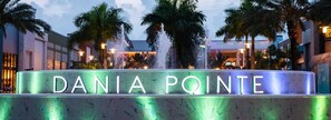 A sign for "Dania Pointe" with a fountain in the background. - Fun in the South and Sun (Hallandale Beach)