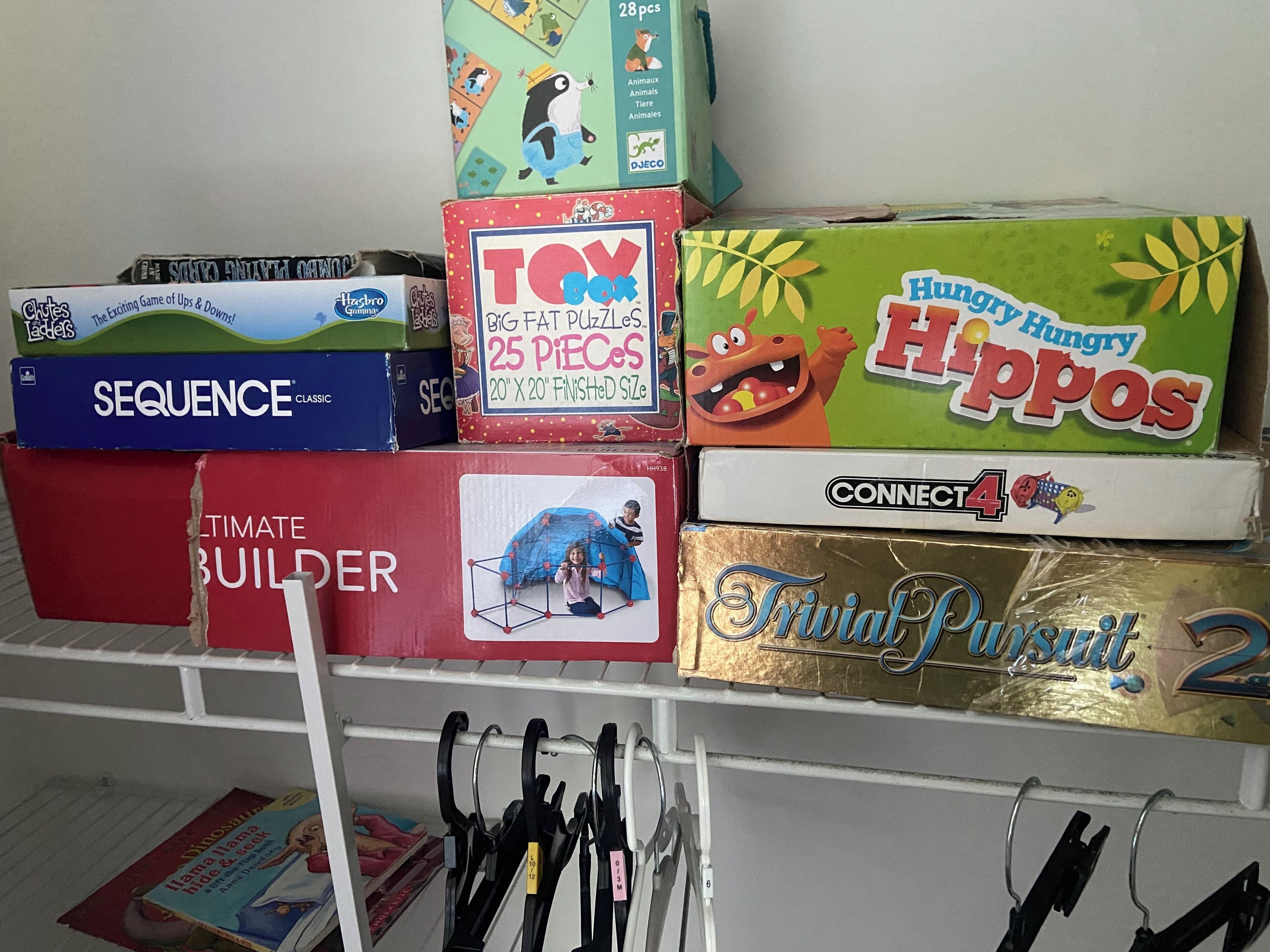 A collection of children's puzzle boxes on a shelf.