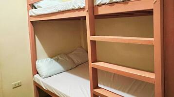A bunk bed with a single mattress and a pillow.