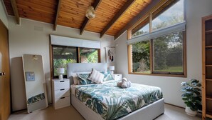A bedroom with a bed, bedside tables, a mirror, a wardrobe, and large windows. - Spacious | Pet Friendly| Near Boat Ramp and Water (Clifton Springs)