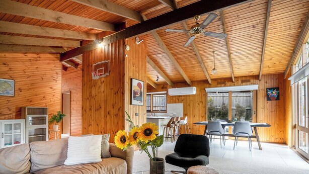 A cozy cabin interior with a wooden ceiling, a dining area, and a living room with a sofa and a coffee table. - Spacious | Pet Friendly| Near Boat Ramp and Water (Clifton Springs)