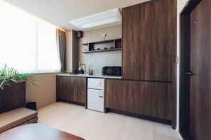 Mini-fridge, microwave, stovetop, cookware/dishes/utensils