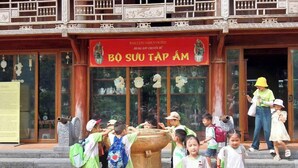 A traditional building with a red sign reading "BO SUU TAP AM" and a large decorative water feature in front. - KST Linh Ky Moc (Quang Phu)
