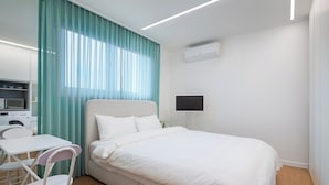 A modern bedroom with a bed, a desk, and a chair. - StayLink (Seoul)