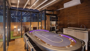 A billiards table with a city view, wooden flooring, and a modern kitchen area. - StayLink (Seoul)