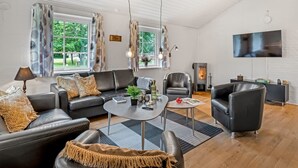 A modern living room with a sofa, coffee table, and a fireplace. - "Guthbrand" - 1.3km from the sea by Interhome (Blåvand)