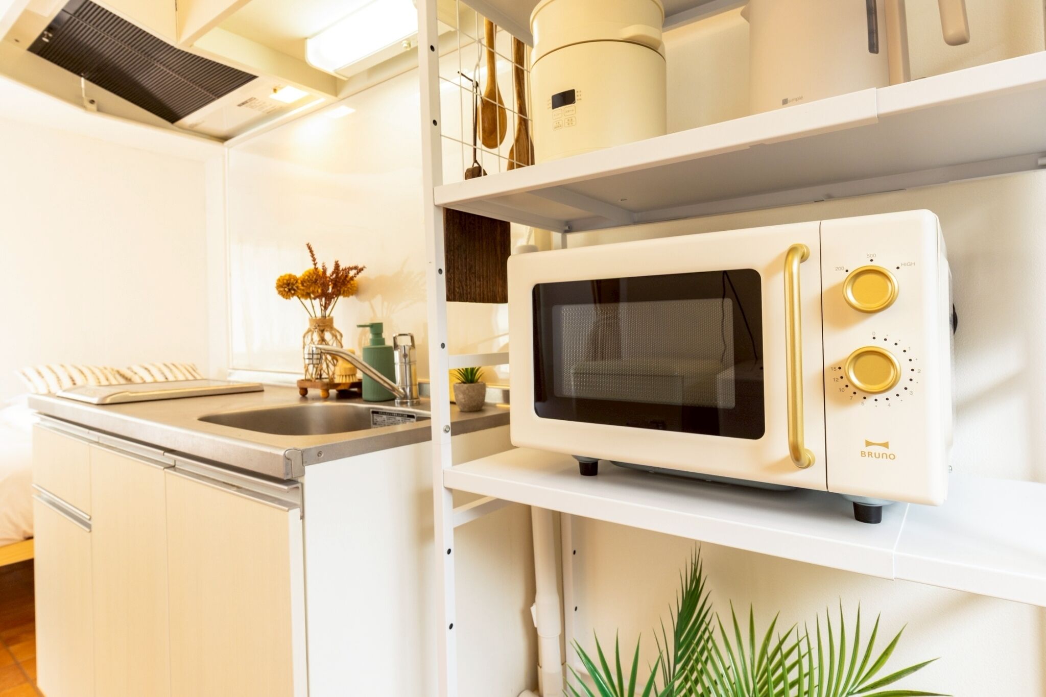 A compact kitchen with a built-in microwave, a sink, and a small countertop.