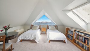 A bedroom with two beds, a desk, a chair, a bookshelf, and a skylight. - Blue Mountains Rhapsody - Point Blank Views Clifftop (Leura)