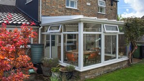 A two-story house with a conservatory, brick walls, and a tiled roof. - 2 bedroom accommodation in Pakefield, near Lowestoft (Pakefield, near Lowestoft)