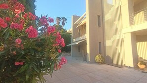 A modern building with balconies and a courtyard.