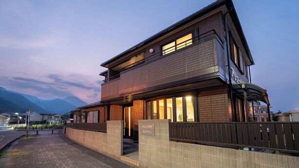 A two-story building with a brick facade, a balcony, and a sign that reads "ALLURE BEPPU". - ALLURE BEPPU (Beppu)