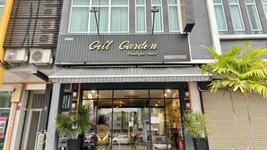 The exterior of the Gill Garden Boutique Hotel with a modern facade, large windows, and a visible entrance. - Gill Garden Boutique Hotel (Malacca City)