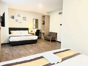 A hotel room with a bed, a desk, a chair, and a wardrobe. - Gill Garden Boutique Hotel (Malacca City)