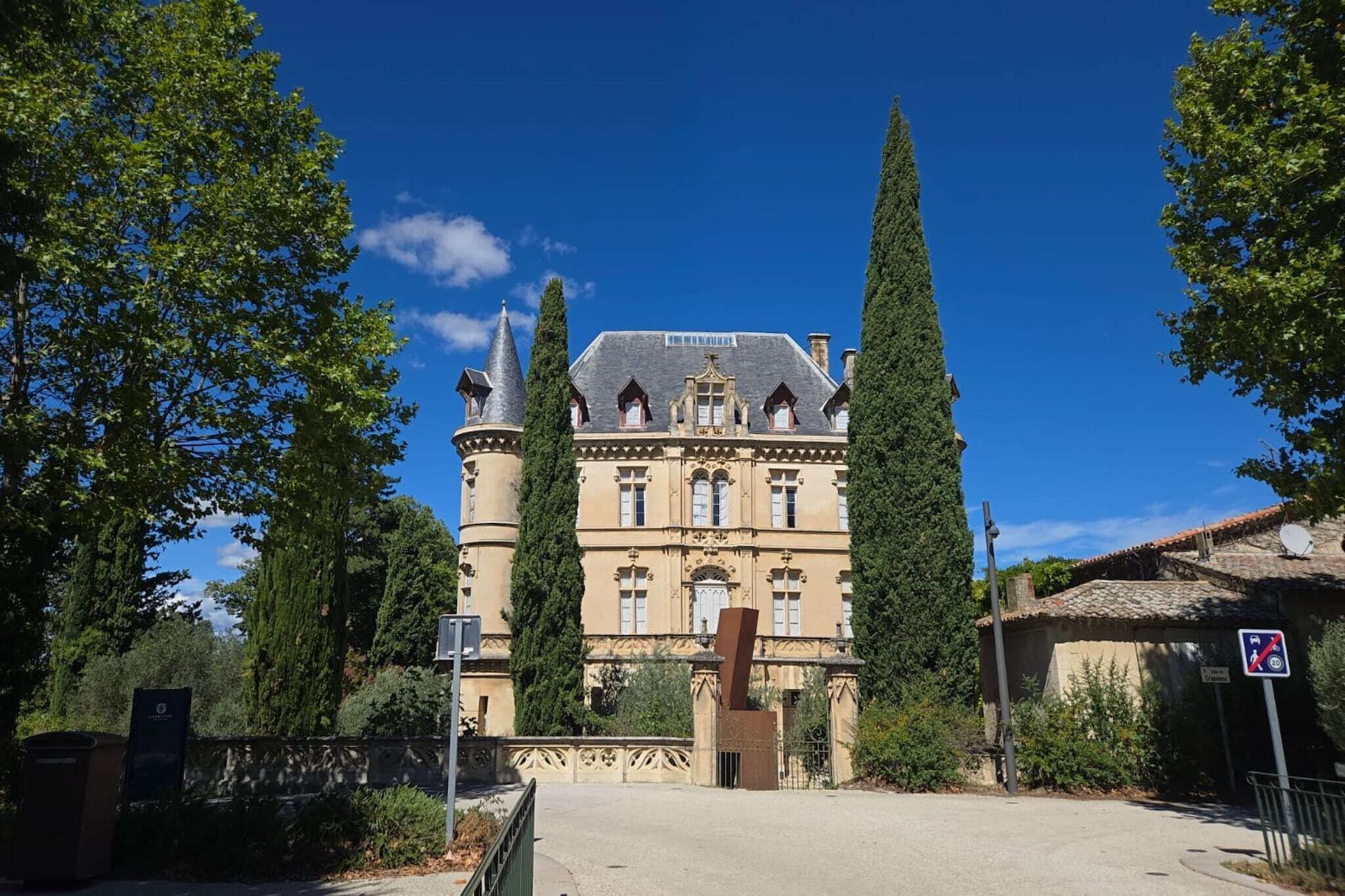 A large, historic building with a symmetrical facade, tall towers, and a central entrance.