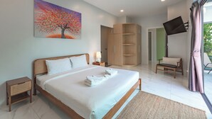 A modern bedroom with a bed, a painting, a wardrobe, a TV, and a bench. - 3BR PoolVilla 7 Mins to Nai Harn V108 (Rawai)