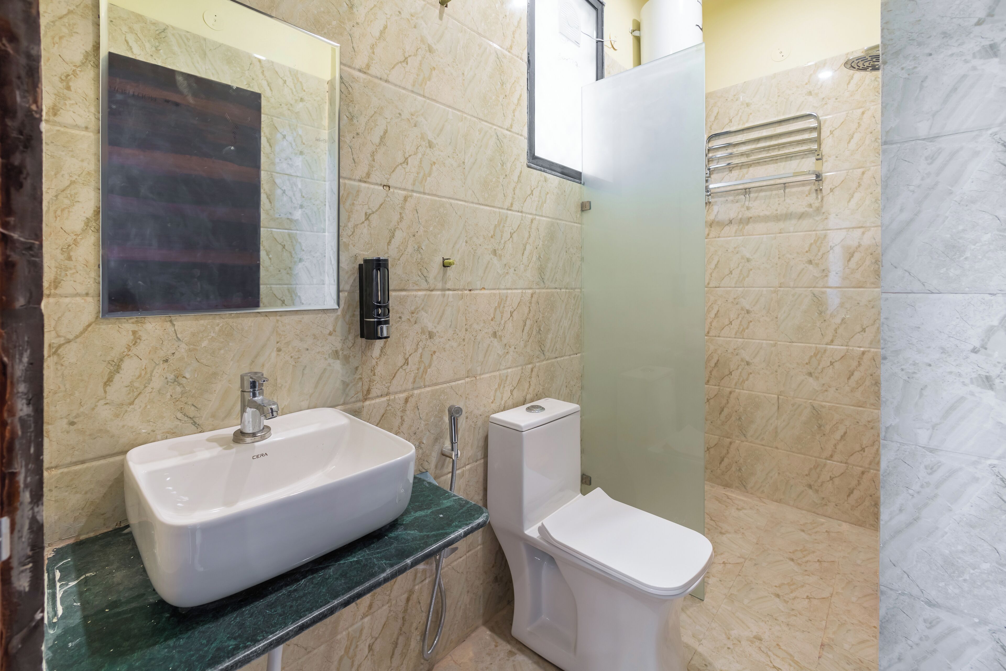 A bathroom with a white sink, a toilet, and a shower area.