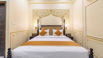 A neatly made bed with a headboard, two bedside tables, and a decorative wall panel.