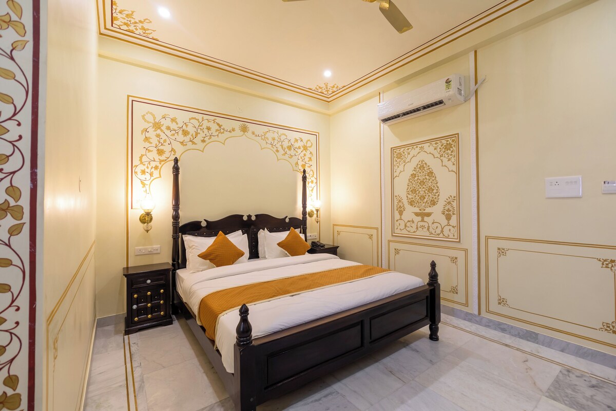 A neatly arranged bedroom with a large bed, bedside tables, and decorative wall panels.