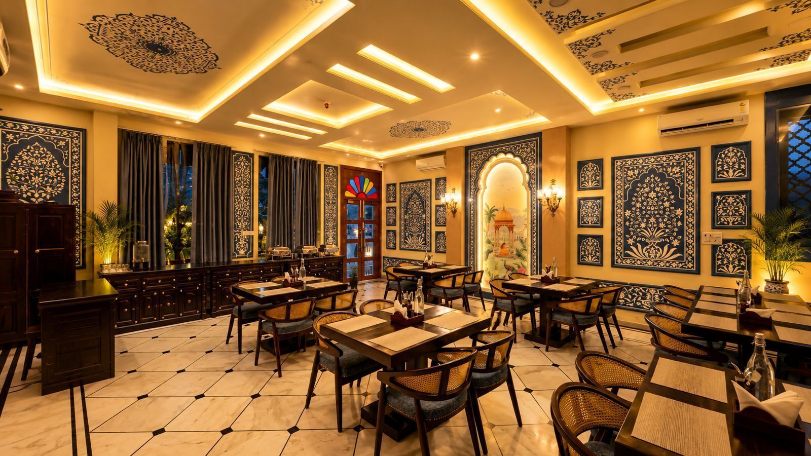 A restaurant with multiple tables, chairs, and decorative wall art.