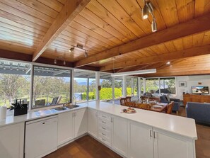 A modern kitchen with white cabinets, a large island, and a view of the outdoors. - Englewood Ridge - A country classic in scenic Lovedale (Lovedale)