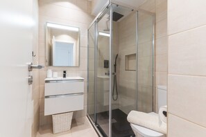 Shower, hair dryer, towels, toilet paper