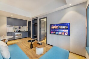 Superior Suite, City View | Living area | 40-inch TV with cable channels
