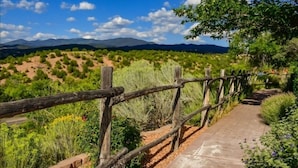 A wooden fence with a concrete pathway. - Art-Filled Casita, Walk to Plaza, Hottub & Pool (Santa Fe)