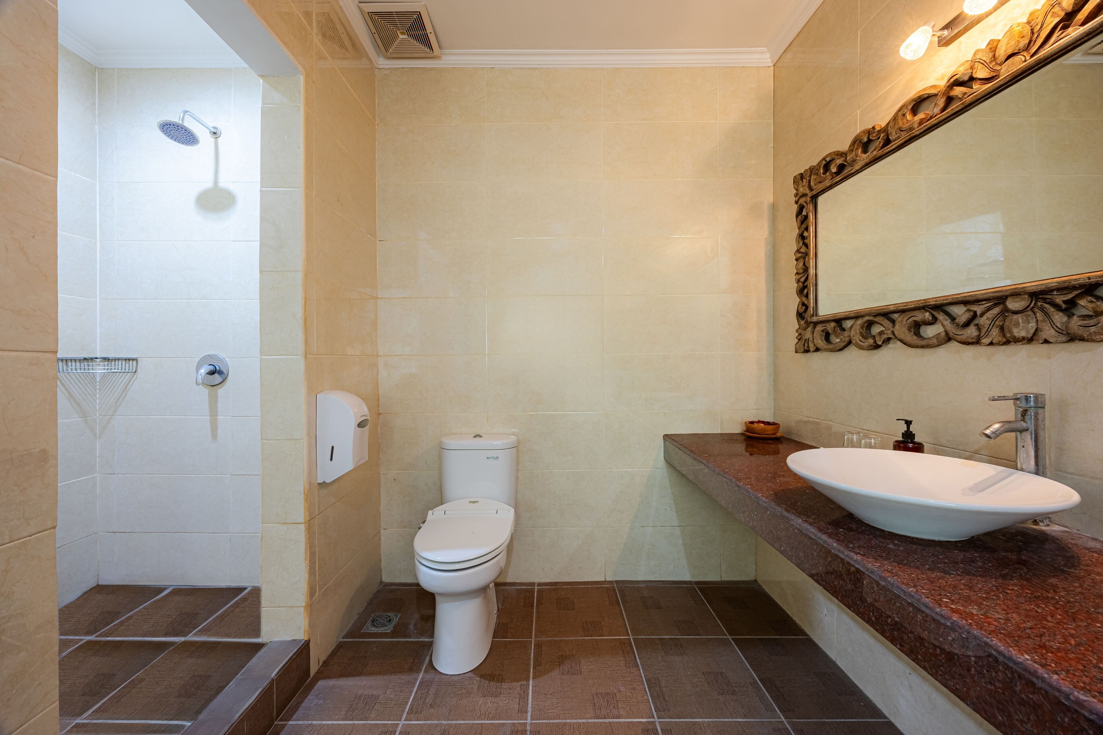 A bathroom with a shower, toilet, sink, and mirror.