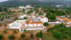 An aerial view of a residential area with houses, a swimming pool, and a road. - Room '2' with Shared Pool (Fortios)