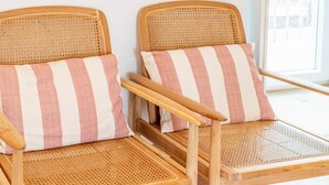 Two wicker chairs with striped cushions, positioned next to a window with a view. - 'Room 3' with Shared Pool (Fortios)