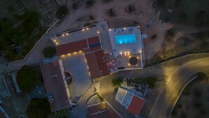 An aerial view of a property with a swimming pool, a covered patio, and a curved driveway. - 'Room 3' with Shared Pool (Fortios)