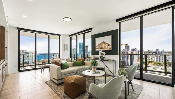 A spacious living room with a large window, a sofa, a coffee table, and a view of the cityscape.