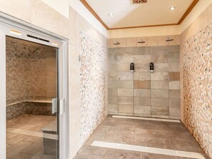 A modern shower area with a glass enclosure, tiled walls, and a showerhead. - Champagny-en-Vanoise, Duplex for 8, Premium Comfort, Wifi and Garage (Champagny-en-Vanoise)