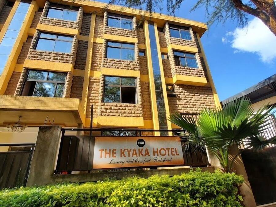 Un hotel de varios pisos con fachada de piedra y grandes ventanales.