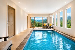 A swimming pool with a view of mountains, a door, and a chair. - Fantastic View|Theater|Indr Pool|Pool Table|HotTub (Sevierville)
