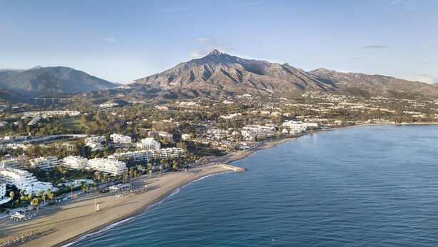 A coastal town with a prominent mountain, beachfront, and residential buildings. - Marbella 22 Beach&Comfort just steps from the sea (Marbella)