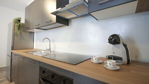 A modern kitchen with stainless steel appliances, a wooden countertop, and a coffee maker. - Sant'Avendrace: Spacious Apt. 3 bedrooms, 2 baths (Cagliari)