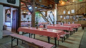 A rustic dining area with wooden tables and benches, a wooden ceiling, and framed pictures on the walls. - Apartment 'Haus 3 2-zimmer' with Lake View, Shared Terrace and Wi-Fi (Meersburg)