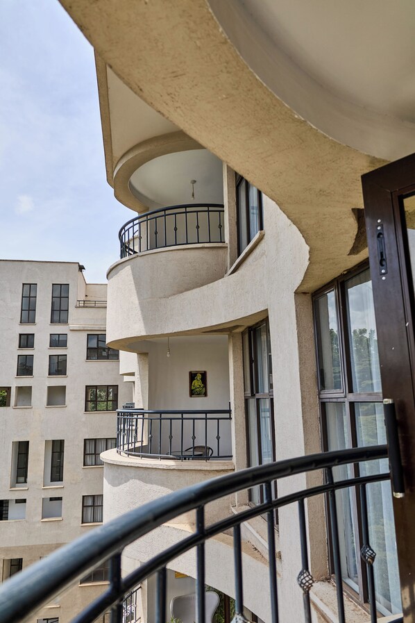 A multi-story building with balconies, large windows, and a curved architectural design. - Sangara by Edmor Suites. (Nairobi)