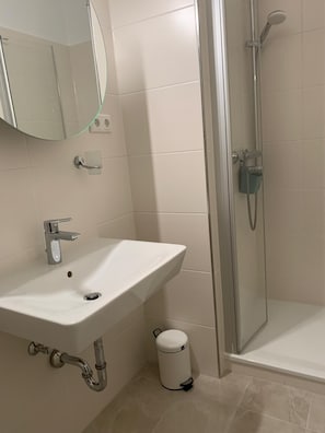 Shower, hair dryer, towels, toilet paper