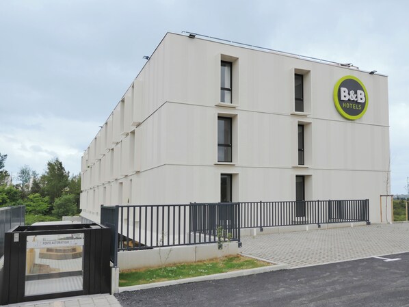 Ein modernes Gebäude mit einem Schild, das "B&B HOTELS" auf der Fassade zeigt.