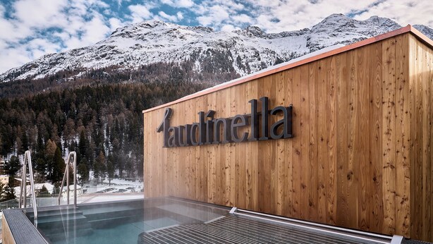A wooden building with a sign reading "Laudinella" and a pool area with steps leading into the water. - The View (St. Moritz)